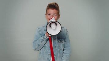 Smiling toddler boy talking with megaphone, proclaiming news, loudly announcing sale advertisement video