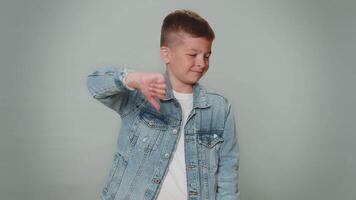 Upset boy in jacket showing thumbs down sign gesture, disapproval, dissatisfied dislike, discontent video