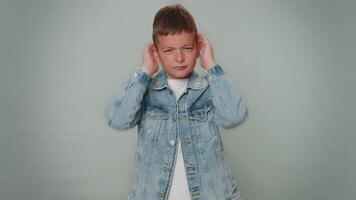 Frustrated annoyed irritated toddler boy covering ears and gesturing No avoiding ignore hear advice video