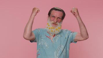 Stylish senior bearded man shouting raising fists in gesture I did it celebrating success winning video
