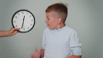 Toddler kid boy with anxiety checking time on clock, running late to work, being in delay, deadline video