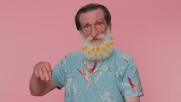 Senior man pointing down, saying to subscribe, gesturing ok and like, showing place for information video