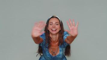 Lovely woman appear from below waving hello with her palm, greeting with hospitable friendly smile video