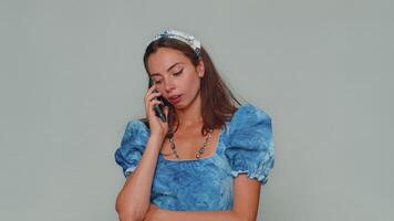 Tired sleepy freelancer young woman talking on mobile phone with friend, making online conversation video