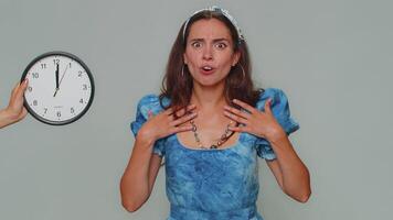 Woman with anxiety checking time on clock, running late to work, being in delay, deadline video