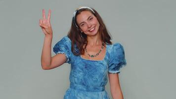 Lovely happy woman showing victory sign, hoping for success and win, doing peace gesture, smiling video