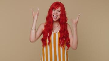 Overjoyed happy girl showing rock n roll gesture by hands, cool sign, shouting yeah with crazy face video