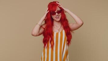 Funny redhead girl making playful silly facial expressions, grimacing, fooling around showing tongue video