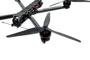 Modern FPV drone on a white back. Four-engine aircraft on the radio control. Drone for racing, filming and entertainment. photo