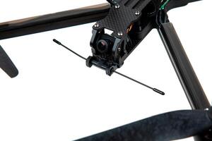 Modern FPV drone on a white back. Four-engine aircraft on the radio control. Drone for racing, filming and entertainment. photo