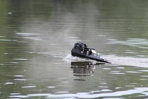 Toy Remote Controlled Boat Speeding Down The River photo
