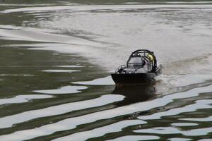 Toy Remote Controlled Boat Speeding Down The River photo