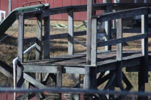 A Small Dock On The Side Of A Pond In The Rural Country photo