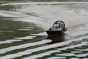 Toy Remote Controlled Speed Boat Speeding Through The Water. photo
