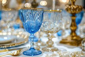 Glassware on a formal dining table set. Blue and clear glasses photo
