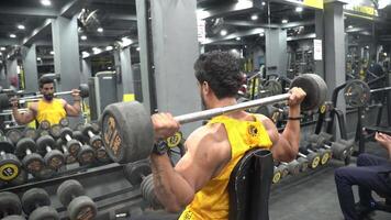 man doing exercise with heavy bar video