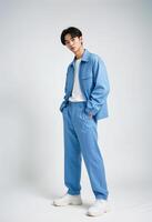 Stylish Young Korean Man in Trendy Blue Outfit. Pose confidently against a neutral background photo
