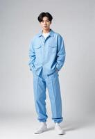 Stylish Young Korean Man in Trendy Blue Outfit. Pose confidently against a neutral background photo