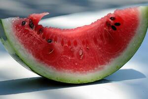 A brightly colored slice of watermelon rests on a table, showcasing its juicy, red flesh and dark seeds, inviting a refreshing taste. photo