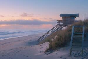A serene dawn beach with pink and blue skies, wooden platform and hut. Beach ready for the day photo