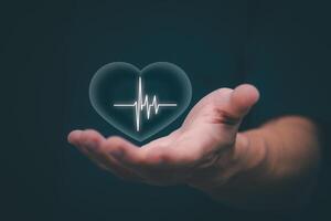 Businessman showing a symbol or icon related to health insurance or healthcare. Concepts for developing and accessing care anywhere, anytime, doing business related to the hospital business photo