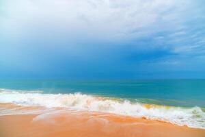 Foam wave, running on the sandy shore. photo