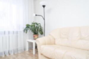 The interior of the apartment with a sofa and a window. Soft focus background. photo