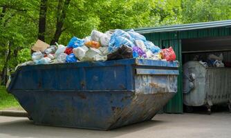 The container for collecting garbage. Plastic bags for garbage in the container. photo