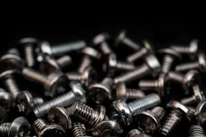 Fixing bolts. Assembly of computers. Technical texture. Dark background. photo