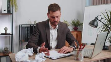 Angry furious man working at home office throwing crumpled paper, having nervous breakdown at work video