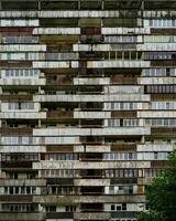 Facade of an old multi-storey residential building with balconies. Rusty facing of balconies. Residential building in the slum. photo