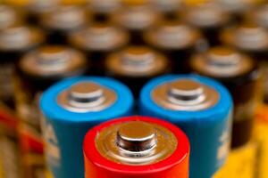 Used batteries are arranged in a triangle shape. Recycling and disposal of toxic waste. photo