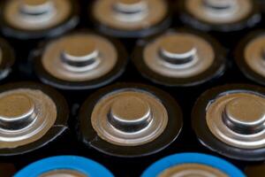 Used batteries are arranged in a triangle shape. Recycling and disposal of toxic waste. photo