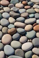 A highresolution image showcasing a serene background of smooth, rounded pebbles in soft, pastel hues, embodying a minimalist and aesthetic concept perfect for calm and soothing designs. photo