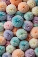 A visually pleasing vertical background featuring an array of soft and fluffy balls in gentle pastel hues, exuding a cozy and adorable atmosphere perfect for creative designs. photo