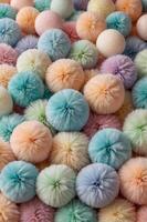 A visually pleasing vertical background featuring an array of soft and fluffy balls in gentle pastel hues, exuding a cozy and adorable atmosphere perfect for creative designs. photo