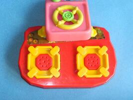 Macro photo of children's cooking toys with a blue background
