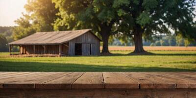 empty wooden table top for product display montages with blurred farm barns and buildings background. photo