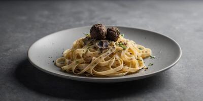 Delicious fettuccine with truffle elegantly presented on a gray table with ample copy space image. photo