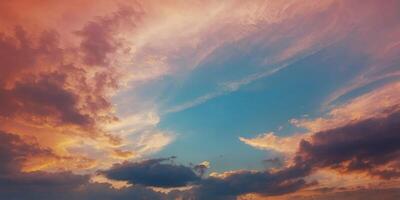 Closeup of the sky as it transforms from a clear pale blue to a canvas of fiery oranges and pinks. photo