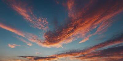 Closeup of the sky as it transforms from a clear pale blue to a canvas of fiery oranges and pinks. photo