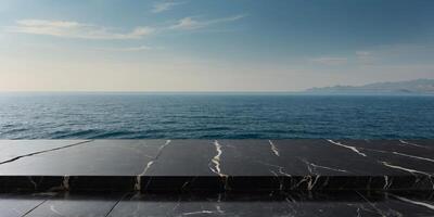 Empty black marble stone table top with sea view background For product display. photo