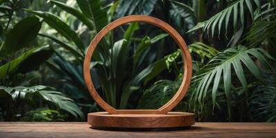 Empty round wooden display stand with a lush tropical foliage backdrop, ideal for product presentation. photo