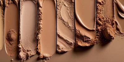 Foundation swatches from light to dark with a mix of powder and liquid foundation products. photo