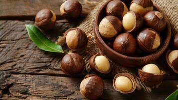 macadamia nuts in a wooden plate on a piece of linen cloth on a wooden table. Aesthetic background photo