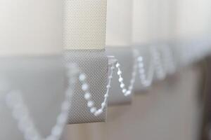 Modern vertical fabric blinds on the window in the office photo
