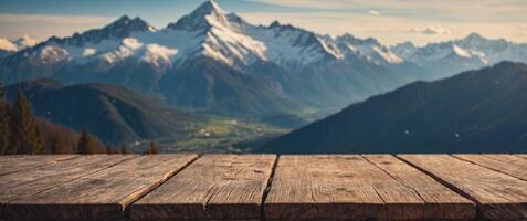 Wooden table with a scenic top with blur background of Alpine with snow capped. photo
