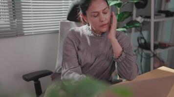 Stressed woman working at dawn Woman full of fatigue while using computer in empty office overworked video