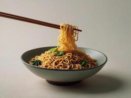 Freshly cooked Dan Dan noodles. With chopsticks in a bowl on white background photo