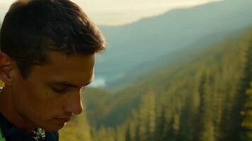 The camera captures the intense concentration on the face of a young male hiker the winding forest path leading deeper into the wilderness.. video